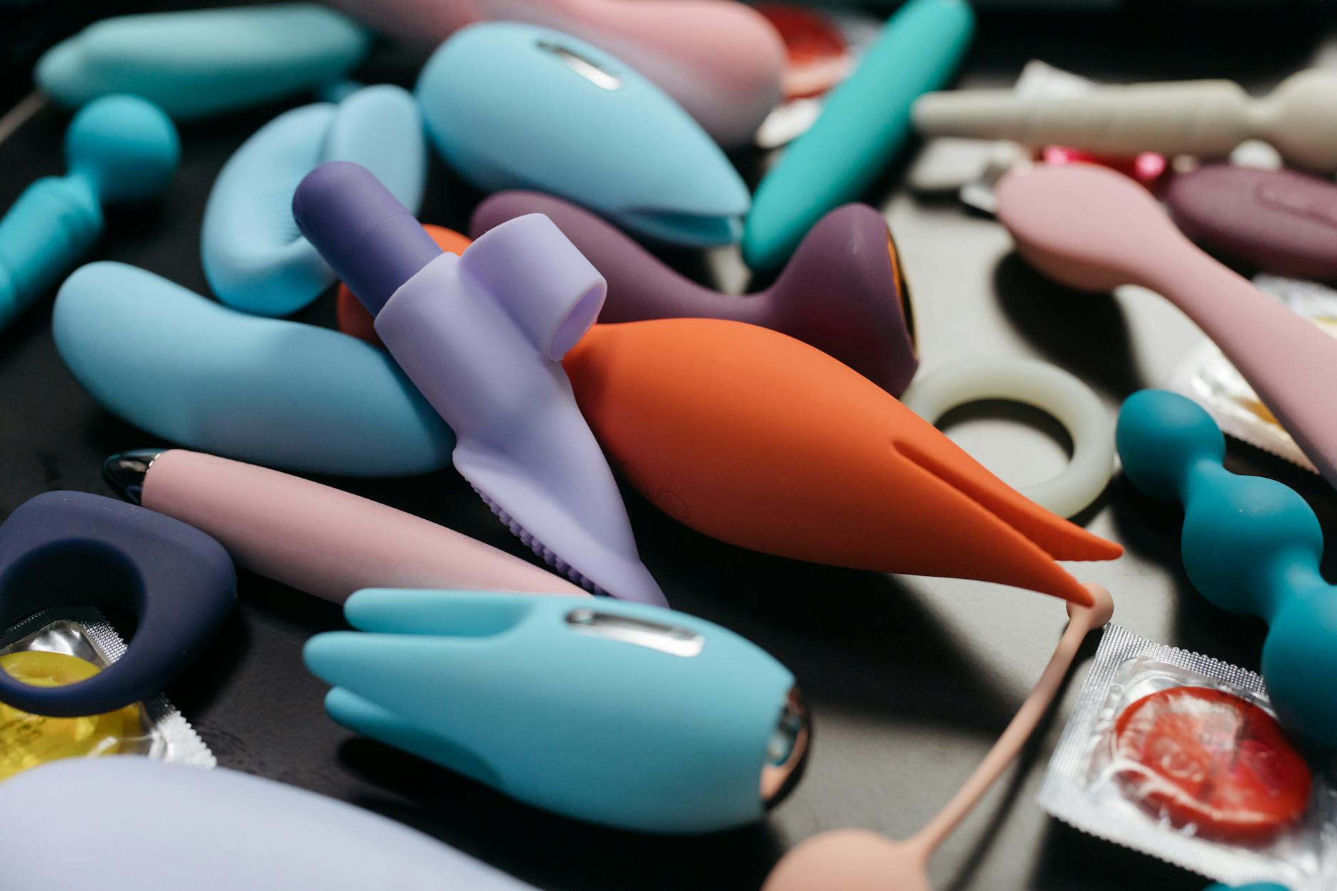 Close-up view of colorful vibrators and intimate wellness products arranged together