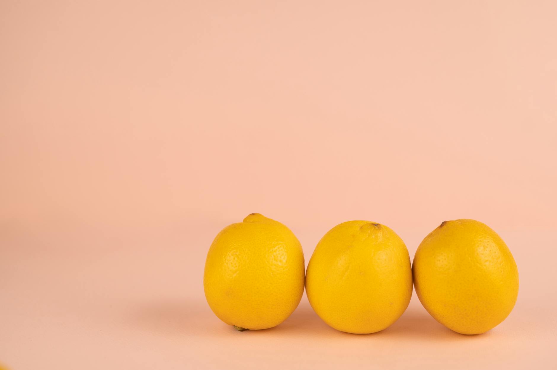 Close-up hands holding a sleek blue vibrator against a purple background