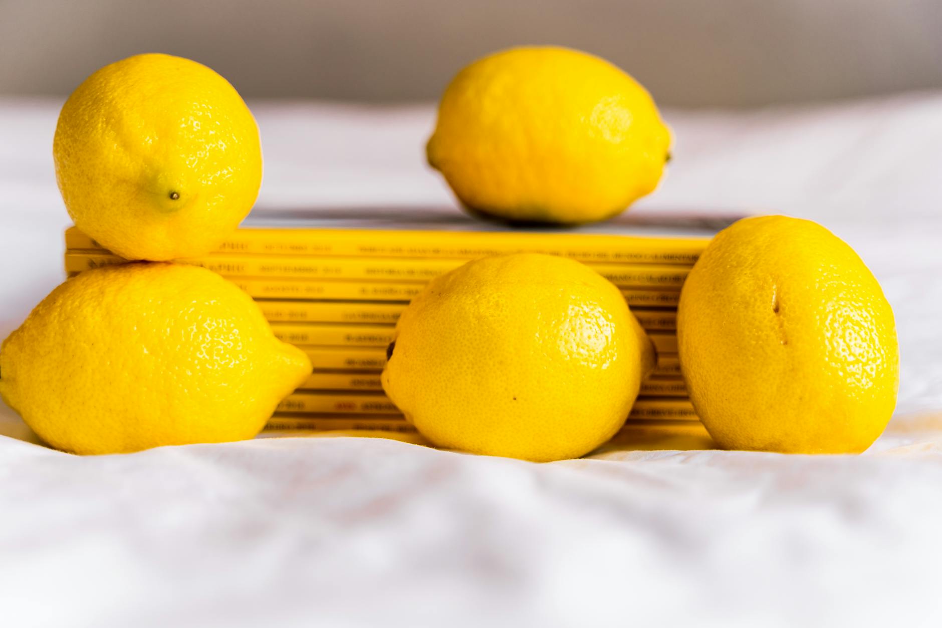 Colorful sex toys including lemon vibrators on bright yellow background